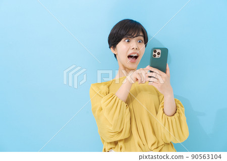 Woman operating a smartphone 90563104