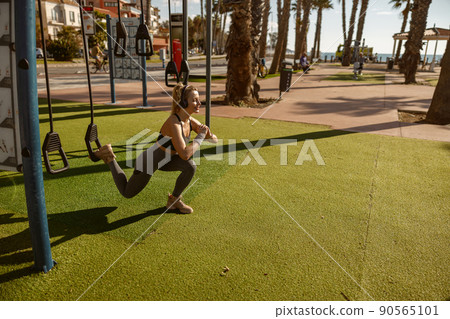 Caucasian athletic woman exercising at city park Caucasian athletic woman exercising at city park 90565101