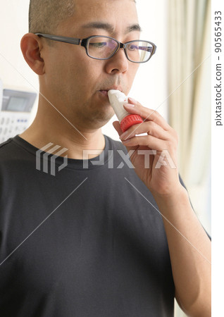 Men using asthma inhalers Men using asthma inhalers 90565433