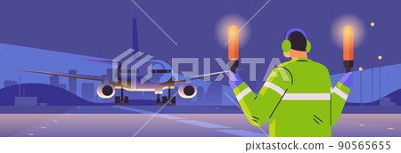 aviation marshaller with light sticks near aircraft air traffic controller airline worker in signal vest professional airport staff 90565655