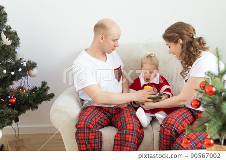 Child with cochlear implant hearing aid having fun with parents in christmas living room - diversity , deafness treatment and medical innovative technologies Child with cochlear implant hearing aid having fun with parents in christmas living room - diversity , deafness treatment and medical innovative technologies 90567002
