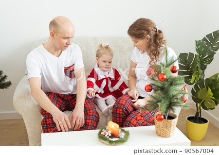 Child with cochlear implant hearing aid having fun with parents in christmas living room - diversity , deafness treatment and medical innovative technologies Child with cochlear implant hearing aid having fun with parents in christmas living room - diversity , deafness treatment and medical innovative technologies 90567004