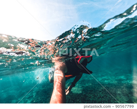 Snorkeling in the sea on a tropical island 90567799