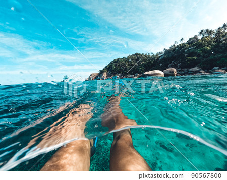 Snorkeling in the sea on a tropical island 90567800