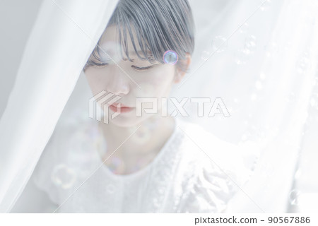 Young woman with soap bubbles and short hair Young woman with soap bubbles and short hair 90567886
