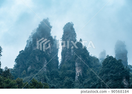 Amazing landscape of mountain and forest in the foggy at Wulingyuan, Hunan, China. Wulingyuan Scenic and Historic Interest Area which was designated a UNESCO World Heritage Site in China Amazing landscape of mountain and forest in the foggy at Wulingyuan, Hunan, China. Wulingyuan Scenic and Historic Interest Area which was designated a UNESCO World Heritage Site in China 90568184