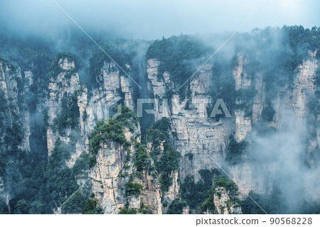 Amazing landscape of mountain and forest in the foggy at Wulingyuan, Hunan, China. Wulingyuan Scenic and Historic Interest Area which was designated a UNESCO World Heritage Site in China Amazing landscape of mountain and forest in the foggy at Wulingyuan, Hunan, China. Wulingyuan Scenic and Historic Interest Area which was designated a UNESCO World Heritage Site in China 90568228