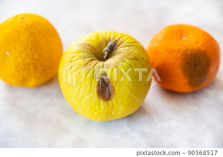 Rotten yellow fruit 90568517