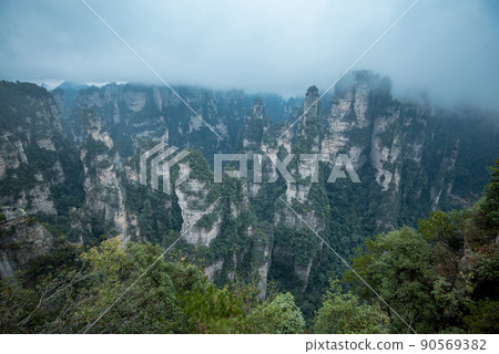 Amazing landscape of mountain and forest in the foggy at Wulingyuan, Hunan, China. Wulingyuan Scenic and Historic Interest Area which was designated a UNESCO World Heritage Site in China Amazing landscape of mountain and forest in the foggy at Wulingyuan, Hunan, China. Wulingyuan Scenic and Historic Interest Area which was designated a UNESCO World Heritage Site in China 90569382