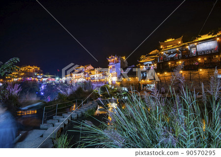 Furong Ancient Town illuminated at night. Amazing beautiful landscape scene of Furong Ancient Town (Furong Zhen, Hibiscus Town), China 90570295
