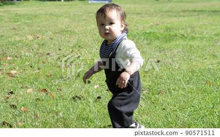 Image of a half-child walking on the lawn Image of a half-child walking on the lawn 90571511