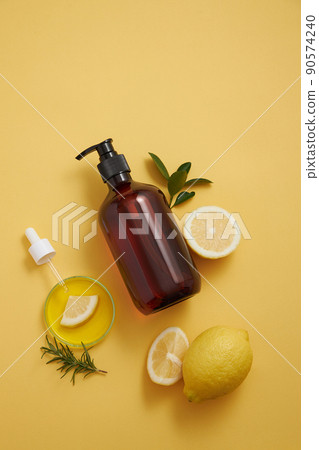 Lemon extract in petri dish and dropper lemon and sliced lemon , green leaf in a yellow background cosmetic template for cosmetic advertisin , top view , photography experiment content Lemon extract in petri dish and dropper lemon and sliced lemon , green leaf in a yellow background cosmetic template for cosmetic advertisin , top view , photography experiment content 90574240