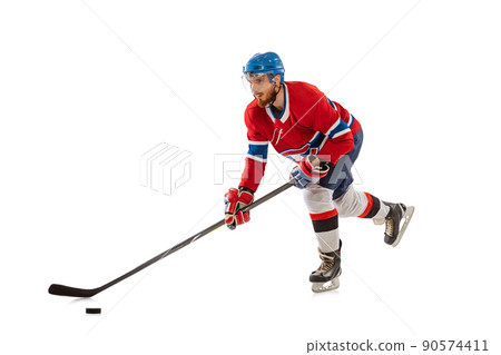 Young male hockey player in sports uniform and protective equipment training isolated on white background. Concept of sport, healthy lifestyle, motion, movement, action. 90574411