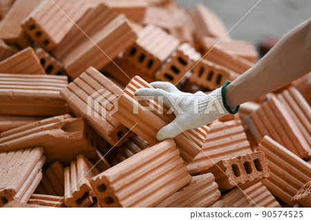 Close up view male bricklayer working on construction site. Concept of repair and building materials 90574525