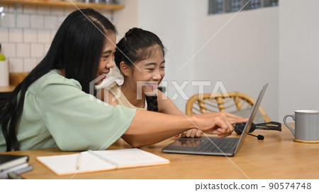 Cute asian girl with mother doing homework at home. Education and school concept Cute asian girl with mother doing homework at home. Education and school concept 90574748
