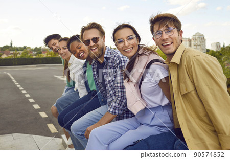 Group portrait of cheerful young multiethnic friends having fun in the city all together 90574852