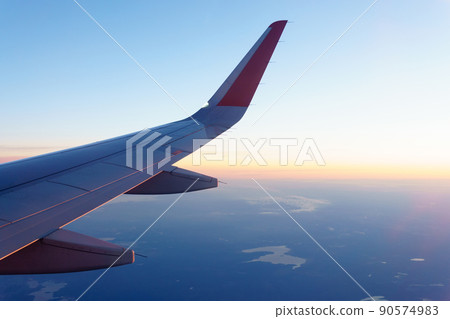 Wing of an airplane. Travel tourism air transportation concept. Selective focus 90574983
