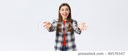 Lifestyle, different emotions, leisure activities concept. I am happy for you. Cheerful and excited young girl, attractive woman in checked shirt reach hands forward to hug and congratulate friend Lifestyle, different emotions, leisure activities concept. I am happy for you. Cheerful and excited young girl, attractive woman in checked shirt reach hands forward to hug and congratulate friend 90576347
