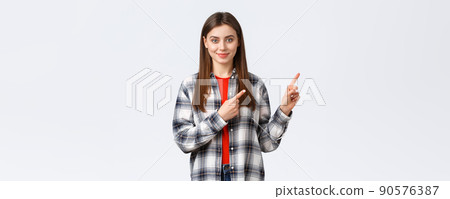 Lifestyle, different emotions, leisure activities concept. Determined smiling female student pointing fingers upper right corner, inform freshman new opportunities, educational program 90576387