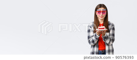 People lifestyle, holidays and celebration, emotions concept. Cute and silly birthday girl in funny glasses, look away think of wish as blowing lit candle on b-day cake, smiling excited People lifestyle, holidays and celebration, emotions concept. Cute and silly birthday girl in funny glasses, look away think of wish as blowing lit candle on b-day cake, smiling excited 90576393