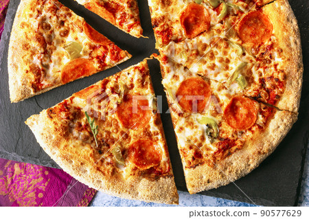 Chorizo pizza on black slate board. Top view. 90577629