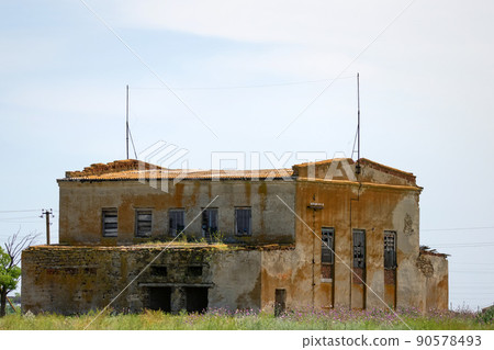 Old single abandoned ruins of industrial building 90578493