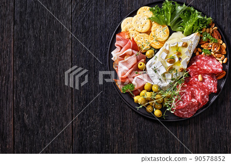 savory baked brie with crackers, salami, nuts, ham savory baked brie with crackers, salami, nuts, ham 90578852