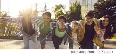 Group of cheerful young international friends hanging out and having fun together Group of cheerful young international friends hanging out and having fun together 90579023