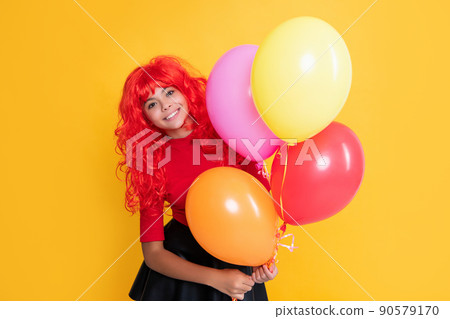 glad kid with party balloon on yellow background glad kid with party balloon on yellow background 90579170