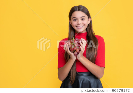 cheerful kid hold bunch of grapes on yellow background cheerful kid hold bunch of grapes on yellow background 90579172