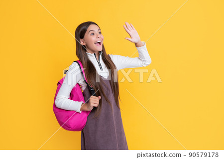 amazed child with school backpack on yellow background amazed child with school backpack on yellow background 90579178