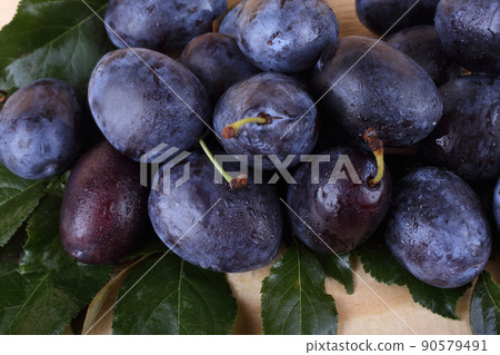 Plums on table 90579491