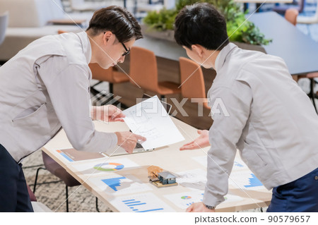 Engineers discussing construction plans Engineers discussing construction plans 90579657