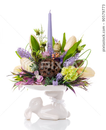 A vase stand, a white bunny holds a composition of flowers. A vase stand, a white bunny holds a composition of flowers. 90579773