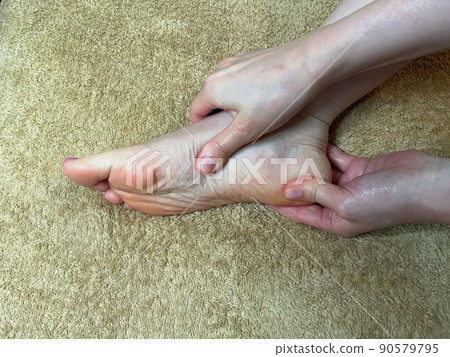 The soles of Asian women with beautiful nails who massage their feet The soles of Asian women with beautiful nails who massage their feet 90579795