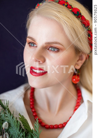 Portrait of a blonde young woman with creative makeup and red accessories Portrait of a blonde young woman with creative makeup and red accessories 90579825