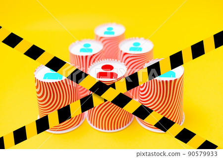 Paper cups arranged in a pyramid shape, with the image of the little man's symbols on the bottom. Blocked by a barrier tape. The concept of business management and career 90579933