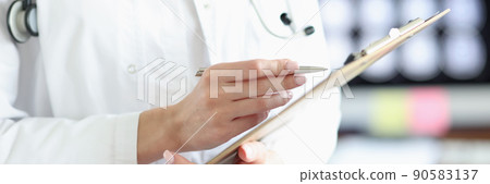 Doctor in medical gown hold clipboard with prescription paper Doctor in medical gown hold clipboard with prescription paper 90583137