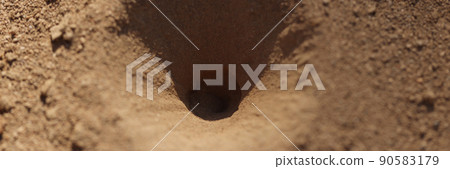 Old small hole in ground or steppe or field with texture of soil and sand Old small hole in ground or steppe or field with texture of soil and sand 90583179