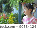 beautiful and cute little girl is looking at the space with graden background 90584124