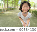 cute little girl smile with beautiful pose in the garden with copy space 90584130