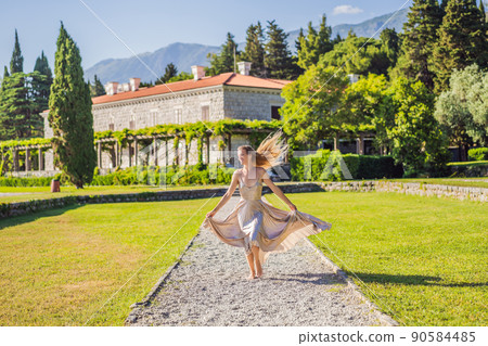 Woman tourist walking in Montenegro. Panoramic summer landscape of the beautiful green Royal park Milocer on the shore of the the Adriatic Sea, Montenegro 90584485
