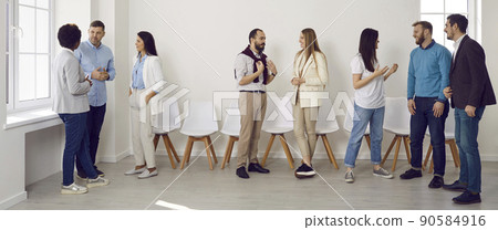 Group of young people meeting and communicating at a business event in the office 90584916