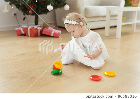 Child girl with cochlear implant plays at home. Hear impairment and diversity and hearing aid copy space and place for advertising 90585010