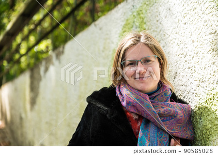 Attractive thirty year old woman,  posing against a rough wall 90585028