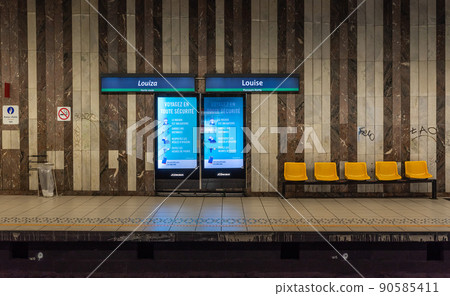 Ixelles, Brussels - Belgium - People of mixed races waiting for the underground metro at the Louisa local train stop 90585411