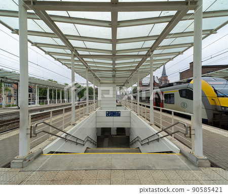 Jette, Brussels Capital Region - Belgium - Almost empty platforms and tracks of the local jette Railwaystation Jette, Brussels Capital Region - Belgium - Almost empty platforms and tracks of the local jette Railwaystation 90585421
