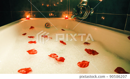 bathtub with romantic atmosphere and scented candles 90586207