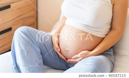 Pregnancy yoga meditation. Health yoga home sport. Beautiful pregnant woman meditating while sitting in lotus position. Concept maternity, pregnancy, childbirth. 90587215