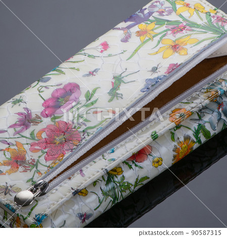 Closeup of a fashionable leather wallet on a dark background 90587315